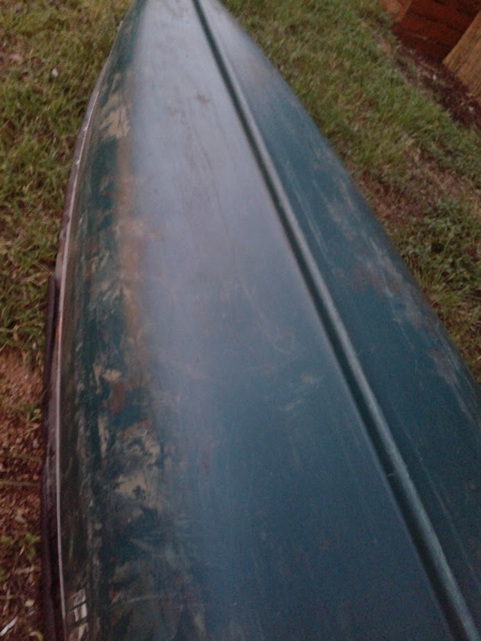 a canoe after its coat of spray paint has fallen off