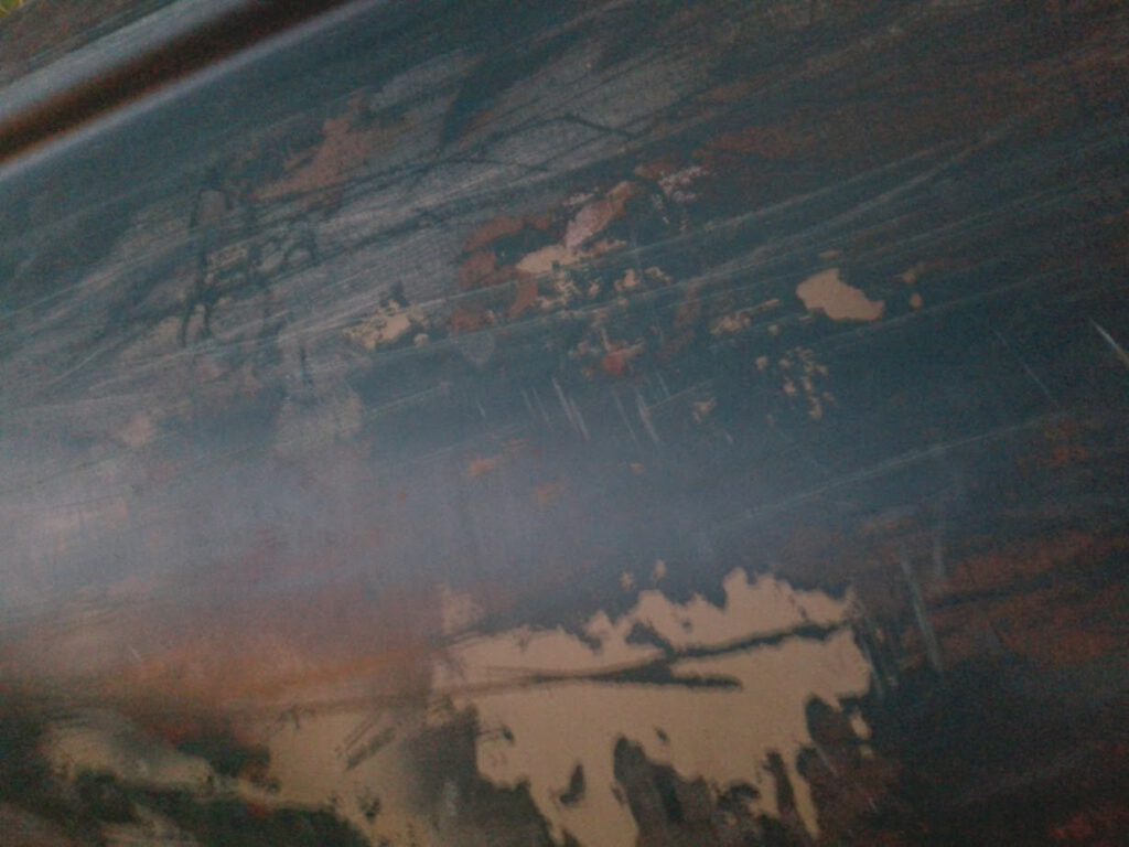 closeup of paint rubbed off from a canoe
